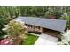 Lovely aerial view of a brick home with a gray roof, attached carport, and blossoming trees at 3755 Kayanne Ct, Tucker, GA 30084