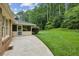 Serene backyard with lush green lawn, screened porch, and mature trees providing shade and privacy at 3755 Kayanne Ct, Tucker, GA 30084