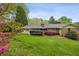Charming backyard featuring lush green lawn and colorful azaleas and nice landscaping at 3755 Kayanne Ct, Tucker, GA 30084