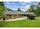 Large backyard with an enclosed patio, mature trees, and well-maintained lawn, perfect for entertaining at 3755 Kayanne Ct, Tucker, GA 30084