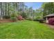 A spacious backyard with a lush lawn and mature trees; perfect for outdoor activities at 3755 Kayanne Ct, Tucker, GA 30084