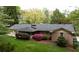 Brick home featuring a spacious backyard with lush landscaping and a screen porch at 3755 Kayanne Ct, Tucker, GA 30084