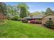 Brick home with a well-maintained backyard, patio area, and vibrant landscaping at 3755 Kayanne Ct, Tucker, GA 30084