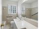 Bathroom with a wide vanity, large mirror, and a window that provides natural light at 3755 Kayanne Ct, Tucker, GA 30084