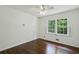 Bright bedroom with hardwood floors, a ceiling fan, and a double window that provides lots of natural light at 3755 Kayanne Ct, Tucker, GA 30084