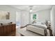 Comfortable bedroom with neutral tones, soft lighting, and en suite access to bathroom with vanity at 3755 Kayanne Ct, Tucker, GA 30084