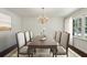 Elegant dining room with a chandelier, large table, and sunlit windows, ideal for formal gatherings at 3755 Kayanne Ct, Tucker, GA 30084
