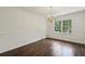 Bright dining room featuring wood floors, crown molding, and a charming chandelier at 3755 Kayanne Ct, Tucker, GA 30084
