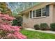 Brick home featuring classic shutters and beautifully landscaped front yard with colorful flowering bushes at 3755 Kayanne Ct, Tucker, GA 30084