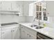 Close up of a bright kitchen featuring quartz countertops, subway tile backsplash, and stainless faucet at 3755 Kayanne Ct, Tucker, GA 30084