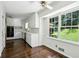 Eat-in kitchen with white cabinets, stainless appliances, hardwood floors and sun-filled windows at 3755 Kayanne Ct, Tucker, GA 30084