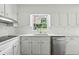 Updated kitchen featuring white cabinets, stainless appliances, and quartz countertops at 3755 Kayanne Ct, Tucker, GA 30084