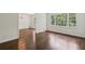 Open-concept living room featuring wood floors, neutral walls, chandelier and backyard views from expansive window at 3755 Kayanne Ct, Tucker, GA 30084