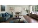 Stylish living room with modern decor, hardwood floors, and a view into the dining area, perfect for entertaining at 3755 Kayanne Ct, Tucker, GA 30084