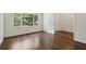 Sunlit living room showcasing hardwood floors, view of the yard, and access to the front entryway at 3755 Kayanne Ct, Tucker, GA 30084
