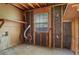 Unfinished basement space with exposed beams, concrete floor, and a window for natural light at 140 Carriage Cir, Stockbridge, GA 30281