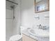 A bathroom features a white toilet, sink and shower at 140 Carriage Cir, Stockbridge, GA 30281