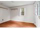 Cozy bedroom with laminate flooring, white walls, and a window providing natural light at 140 Carriage Cir, Stockbridge, GA 30281