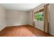 Bright bedroom with hardwood floors, large window with curtains, and neutral wall, creating a serene space at 140 Carriage Cir, Stockbridge, GA 30281