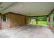 Spacious carport featuring brick columns and access to an enclosed area, perfect for parking and storage at 140 Carriage Cir, Stockbridge, GA 30281
