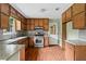 Functional kitchen with wood cabinets, stainless steel oven, and access to backyard perfect for cooking at 140 Carriage Cir, Stockbridge, GA 30281