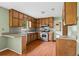 Well-lit kitchen featuring wood cabinets, stainless steel appliances, and a breakfast bar for casual dining at 140 Carriage Cir, Stockbridge, GA 30281