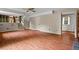 Laminate-floored room featuring stairs to a kitchen, a doorway, and a carpeted staircase at 140 Carriage Cir, Stockbridge, GA 30281