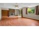 Spacious living room features laminate flooring, brick fireplace, and sliding glass door to the backyard at 140 Carriage Cir, Stockbridge, GA 30281