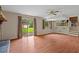 Bright living room with laminate floors, a brick fireplace, and sliding glass doors to the yard at 140 Carriage Cir, Stockbridge, GA 30281