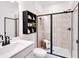 Sleek bathroom with tiled walk-in shower, black framed shower and modern vanity at 330 Meacham Ct, Dacula, GA 30019