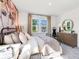 Light-filled bedroom with elegant decor, a large window, and dresser with decorative mirror at 330 Meacham Ct, Dacula, GA 30019
