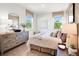 Well decorated bedroom with lots of natural light, dresser and a large stylish mirror at 330 Meacham Ct, Dacula, GA 30019
