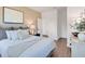Calming bedroom with plush bedding, modern decor, and hallway entry to additional rooms at 330 Meacham Ct, Dacula, GA 30019