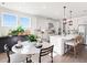 Bright kitchen with a large island, white cabinetry, stainless steel appliances, and a cozy breakfast nook at 330 Meacham Ct, Dacula, GA 30019
