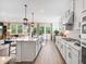 Modern kitchen with white cabinets, stainless steel appliances, and an open layout to the living area at 330 Meacham Ct, Dacula, GA 30019