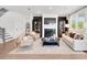 Bright living room with a fireplace, hardwood floors, and comfortable seating arrangement at 330 Meacham Ct, Dacula, GA 30019