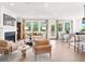 Open-concept living room with fireplace, lots of natural light, and a view of the outdoors at 330 Meacham Ct, Dacula, GA 30019