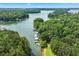 Breathtaking aerial view of a lake surrounded by lush greenery and docks at 3620 Beaver Cove Rd, Cumming, GA 30041