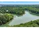 Scenic aerial view of a serene lake with lush green trees and beautiful waterfront properties at 3620 Beaver Cove Rd, Cumming, GA 30041