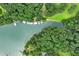 Aerial shot featuring waterfront property with private docks on a serene lake at 3620 Beaver Cove Rd, Cumming, GA 30041