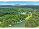 Beautiful aerial view of waterfront properties with private docks and lush surrounding landscape at 3620 Beaver Cove Rd, Cumming, GA 30041