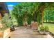 Wooden deck with a trellis and outdoor seating surrounded by landscaping at 3620 Beaver Cove Rd, Cumming, GA 30041