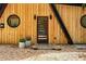 Close-up of the modern front entrance, highlighting the stylish door, round windows, and gravel landscaping at 3620 Beaver Cove Rd, Cumming, GA 30041