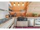 An A-frame kitchen with stainless steel appliances, open shelving, and custom wooden countertops at 3620 Beaver Cove Rd, Cumming, GA 30041