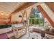 The living area features an open layout with a kitchen, ladder and a floor-to-ceiling window offering an amazing view at 3620 Beaver Cove Rd, Cumming, GA 30041
