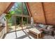 The cozy living room features a large triangular window, providing ample light and nature views at 3620 Beaver Cove Rd, Cumming, GA 30041