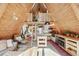 A-frame living room showcasing wood paneling, a loft with ladder, and kitchen with stainless steel appliances at 3620 Beaver Cove Rd, Cumming, GA 30041
