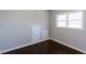 Bright bedroom with hardwood floors, built-in storage, and natural light from a large window at 469 Mellview Sw Ave, Atlanta, GA 30310