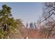 Scenic city view of Atlanta skyline framed by trees, offering a unique urban-nature perspective from the property at 469 Mellview Sw Ave, Atlanta, GA 30310