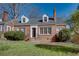 Charming brick home featuring dormer windows, a gray roof, and a well-maintained front yard at 469 Mellview Sw Ave, Atlanta, GA 30310